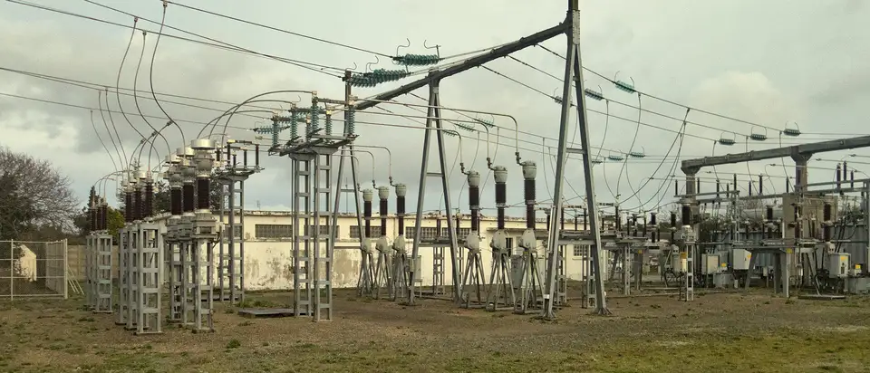 The gantry, switchgear and overhead lines of a high-voltage electricity substation.